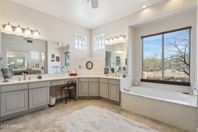 full bathroom featuring a garden tub, ceiling fan, visible vents, and vanity