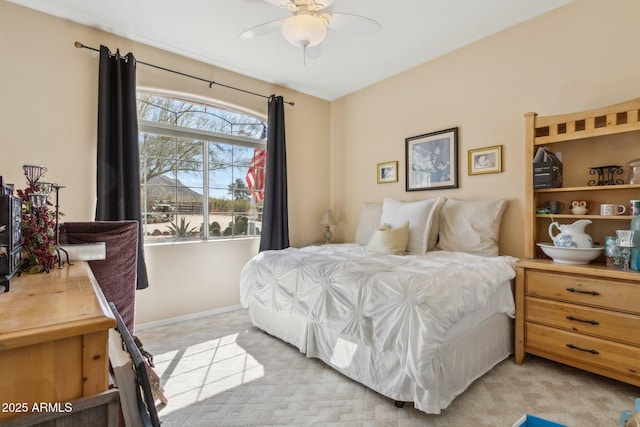 bedroom with light colored carpet and baseboards