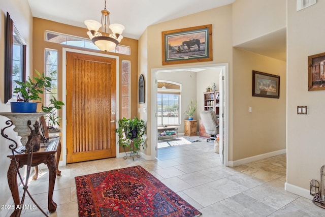 entrance foyer with visible vents, a notable chandelier, and baseboards