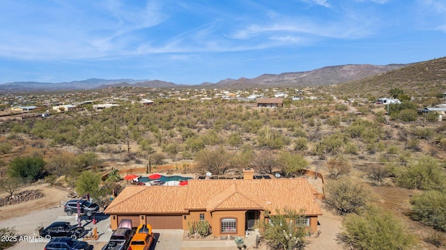 birds eye view of property with a mountain view