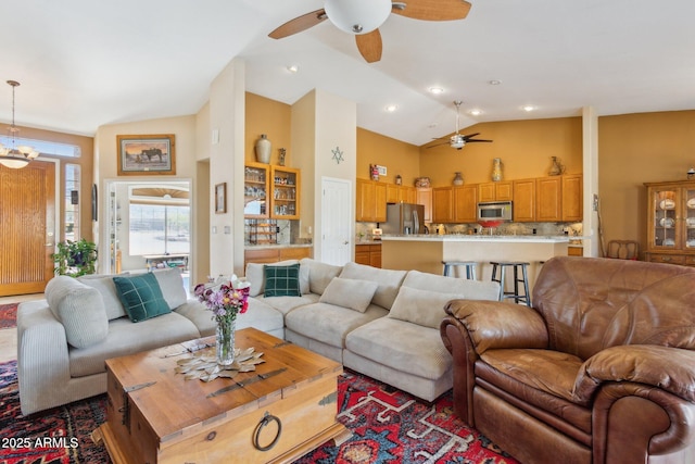 living room with high vaulted ceiling and a ceiling fan