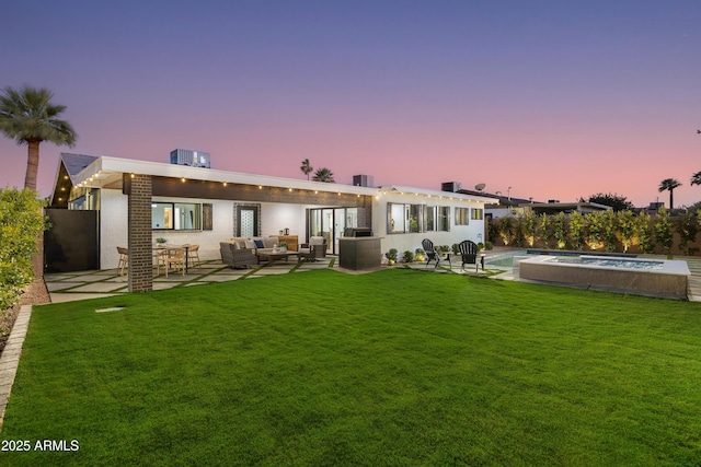 8708 E Rancho Vista Dr, Scottsdale, AZ 85251 - back of property at dusk with an outdoor hangout area, a lawn, an outdoor pool, and a patio