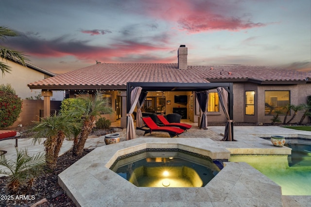 view of swimming pool featuring an in ground hot tub and a patio area