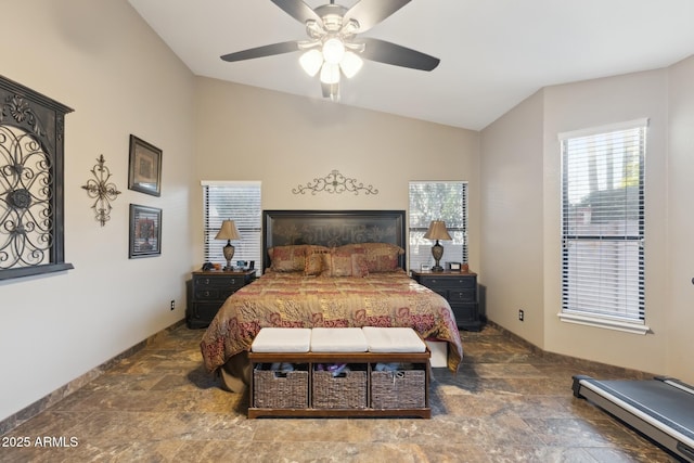 bedroom with lofted ceiling, a baseboard heating unit, and ceiling fan