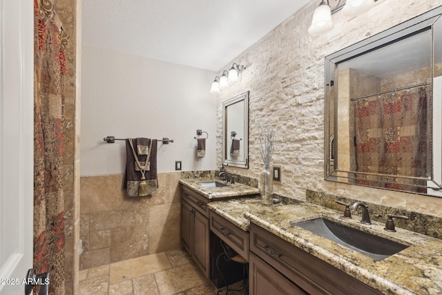 bathroom featuring tile walls and vanity