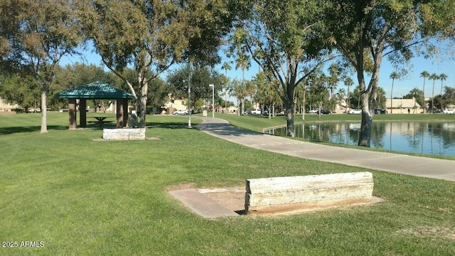 view of property's community with a water view, a yard, and a gazebo