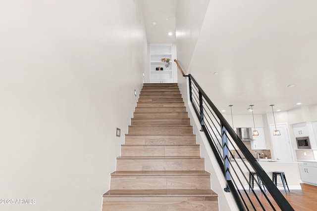 staircase featuring hardwood / wood-style floors