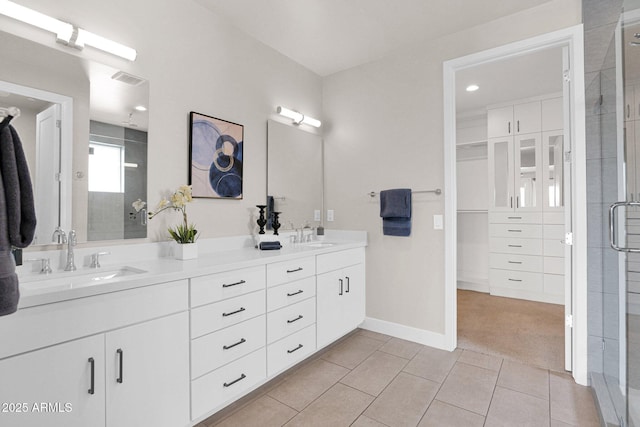 bathroom with tile patterned floors, an enclosed shower, and vanity