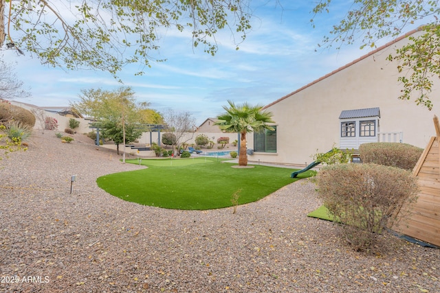 view of yard with a fenced in pool