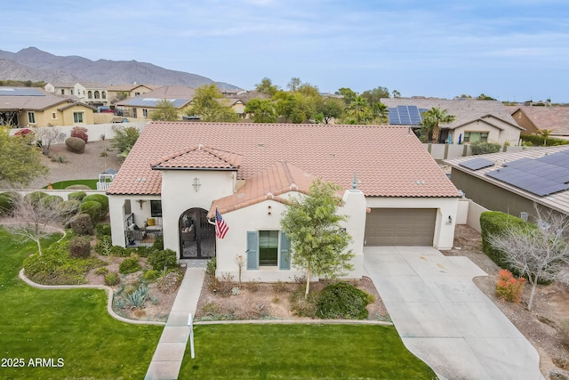 20618 W Western Dr, Buckeye, AZ 85396 - mediterranean / spanish home with a garage, a mountain view, and a front lawn