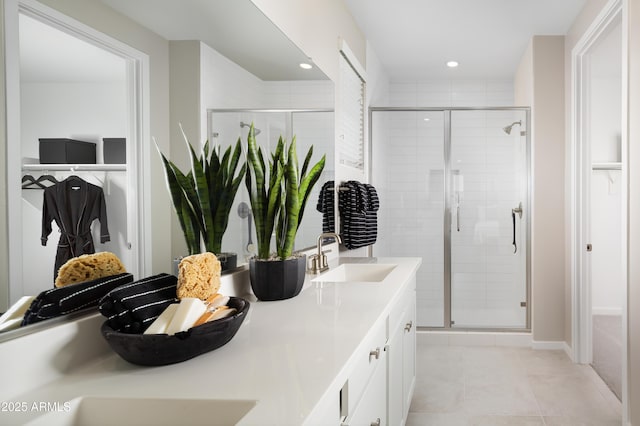 bathroom featuring tile patterned flooring, vanity, and a shower with shower door