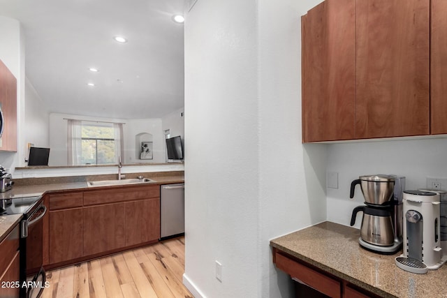 kitchen with sink, light hardwood / wood-style flooring, and stainless steel appliances