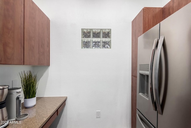 kitchen featuring stainless steel fridge with ice dispenser