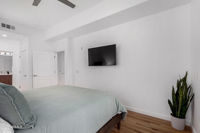 bedroom featuring ceiling fan, wood-type flooring, and connected bathroom