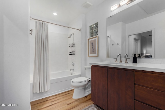 full bathroom featuring shower / bathtub combination with curtain, hardwood / wood-style floors, vanity, and toilet