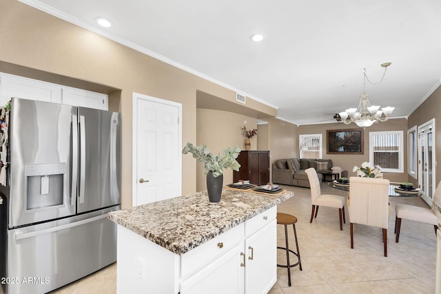 kitchen featuring a notable chandelier, crown molding, visible vents, white cabinetry, and stainless steel fridge with ice dispenser