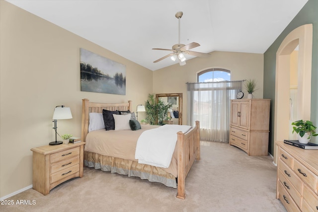 bedroom featuring ceiling fan, vaulted ceiling, and light colored carpet