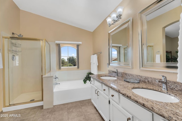 full bathroom with vaulted ceiling, a shower stall, and a sink
