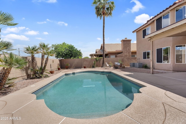 view of pool featuring a patio, a fenced backyard, cooling unit, and a fenced in pool