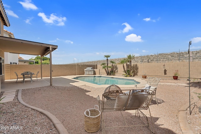 view of swimming pool with a fenced in pool, a fenced backyard, and a patio area