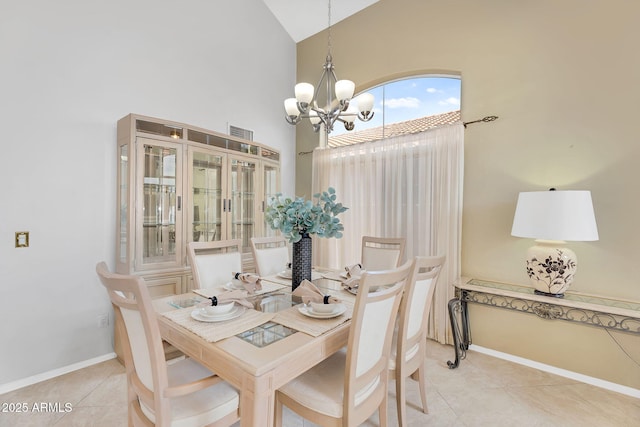 dining space with light tile patterned floors, baseboards, visible vents, a notable chandelier, and high vaulted ceiling