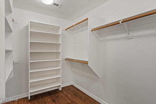 6102 E Danbury Rd, Scottsdale, AZ 85254 - walk in closet with dark wood-style floors