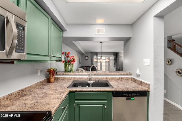 2121 W Union Hills Dr Unit 113, Phoenix, AZ 85027 - kitchen with appliances with stainless steel finishes, a sink, green cabinetry, wood finished floors, and light countertops