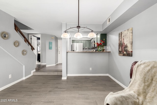 2121 W Union Hills Dr Unit 113, Phoenix, AZ 85027 - kitchen with white fridge with ice dispenser, wood finished floors, stainless steel microwave, and baseboards