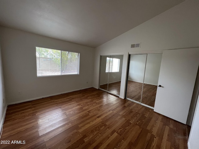 1770 E Sandra Ter, Phoenix, AZ 85022 - unfurnished bedroom featuring vaulted ceiling and dark hardwood / wood-style floors
