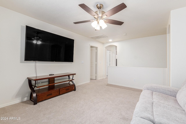 carpeted living room with ceiling fan