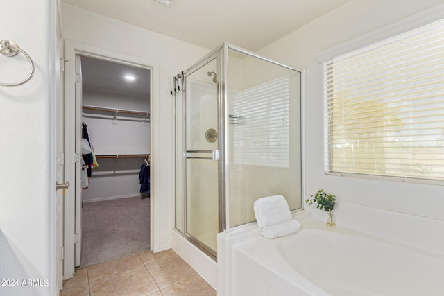 bathroom featuring plus walk in shower and tile patterned floors