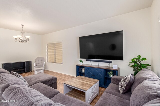 living room with hardwood / wood-style flooring and a chandelier