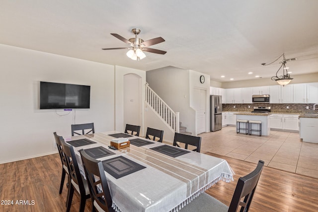 dining room featuring light wood-type flooring and ceiling fan