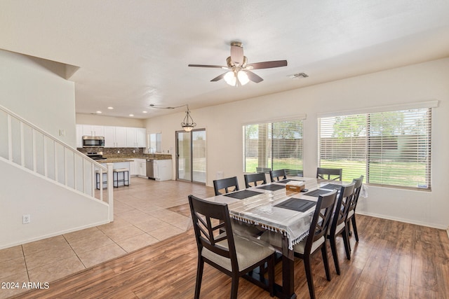 dining area with ceiling fan and light hardwood / wood-style floors