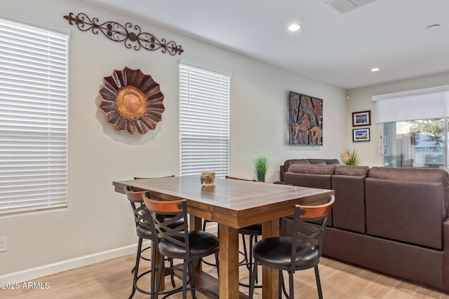 dining space featuring light hardwood / wood-style flooring and a healthy amount of sunlight