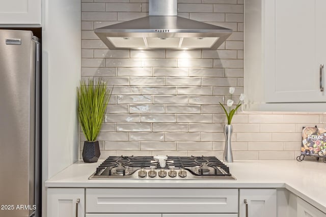 kitchen with white cabinetry, decorative backsplash, ventilation hood, and appliances with stainless steel finishes