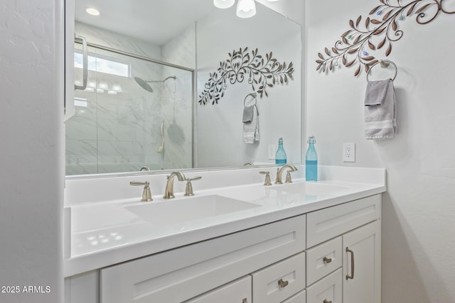 bathroom with vanity and a shower with door