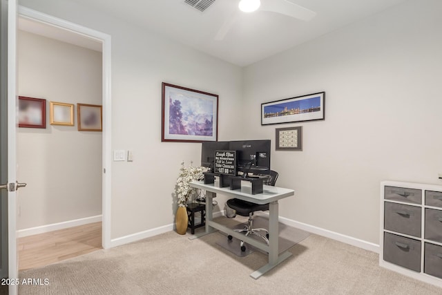 office area featuring light carpet and ceiling fan