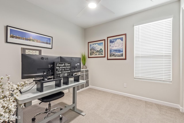 office area featuring light carpet and ceiling fan