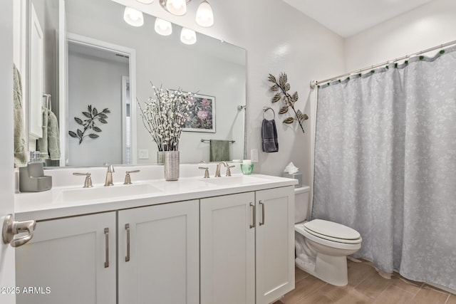 bathroom featuring a shower with shower curtain, vanity, toilet, and hardwood / wood-style floors