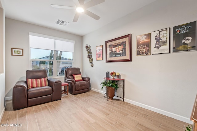 living area featuring ceiling fan and light hardwood / wood-style flooring