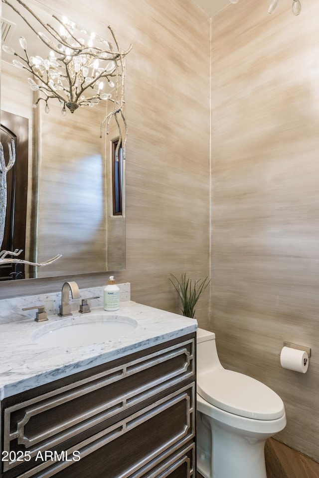 bathroom featuring vanity and toilet