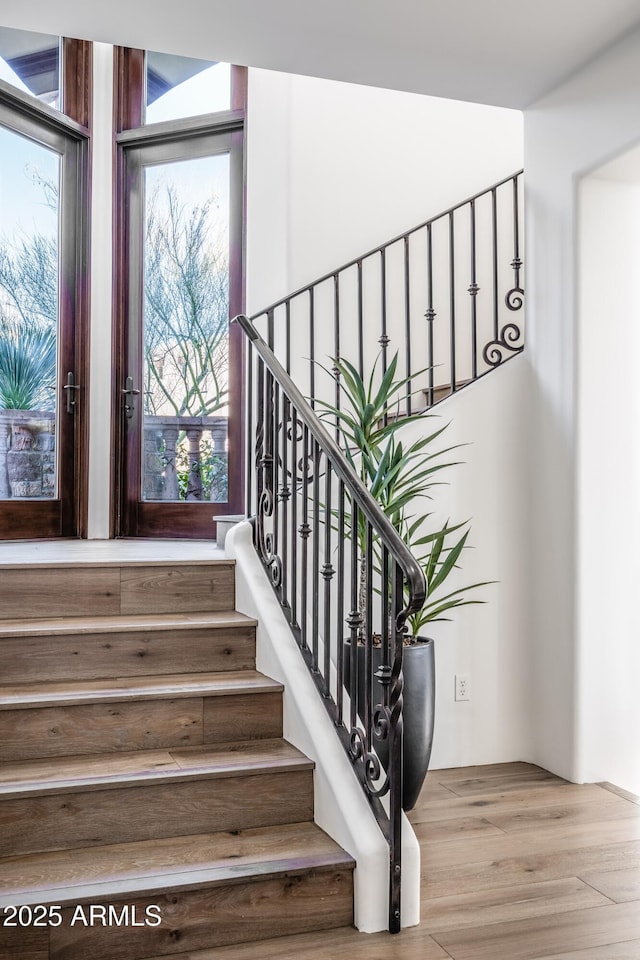 stairs featuring wood finished floors