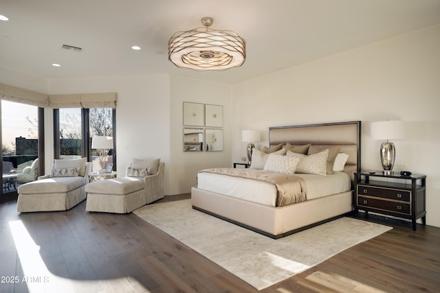 bedroom with wood finished floors, visible vents, and recessed lighting