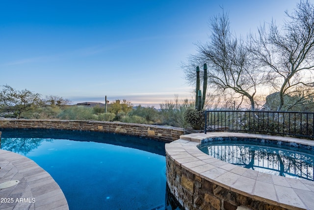 view of pool at dusk