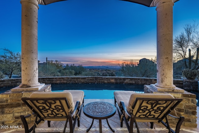 view of patio terrace at dusk