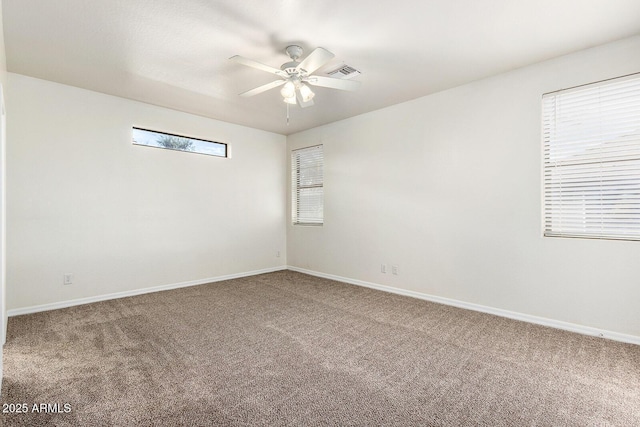 spare room with ceiling fan and carpet