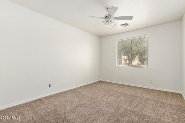 unfurnished room featuring ceiling fan and carpet