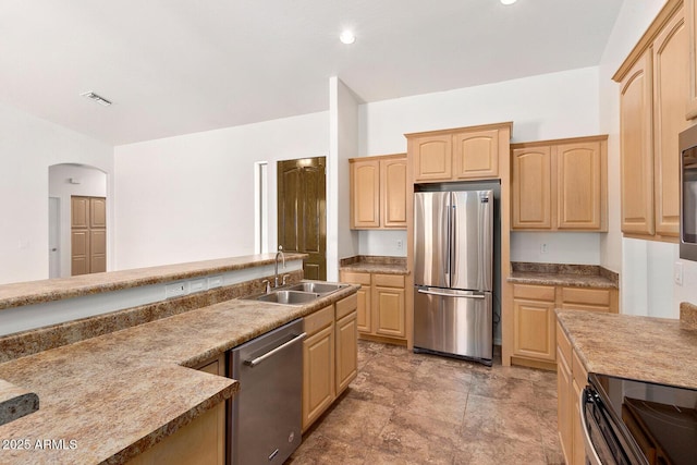 kitchen featuring sink, stainless steel appliances, and light brown cabinets