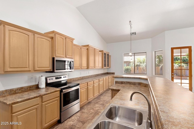 kitchen with light brown cabinetry, sink, vaulted ceiling, appliances with stainless steel finishes, and pendant lighting